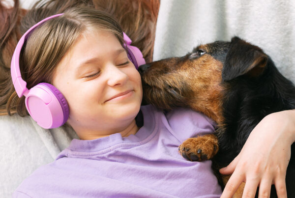 register a microchip - girl and dog enjoying music