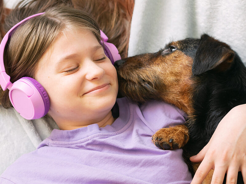register a microchip - girl and dog enjoying music
