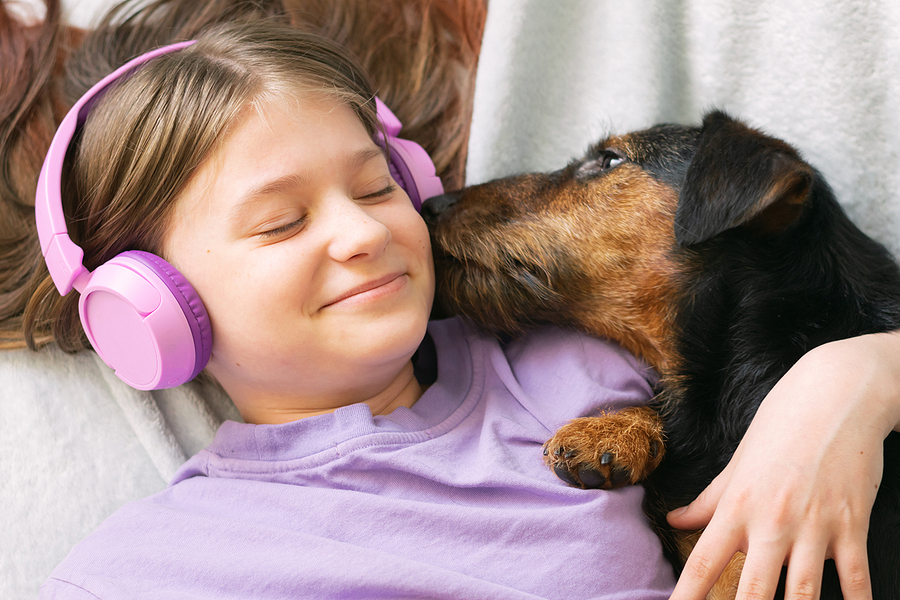 register a microchip - girl and dog enjoying music